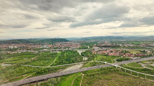 Aerial view of Bologna city in Italy with the Asinelli Towers, San Luca Basilica church on Bologna hill. Bologna train station, Major Hospital and the airport with the A1 Highway