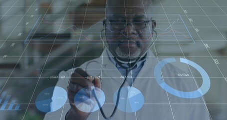 Pointing senior doctor viewing holographic analytics in exam room, lab coat and stethoscope