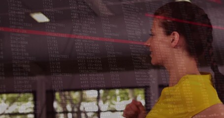 Viewing woman in yellow top studying glass display at lobby, showing REDACTED, red line, copy space