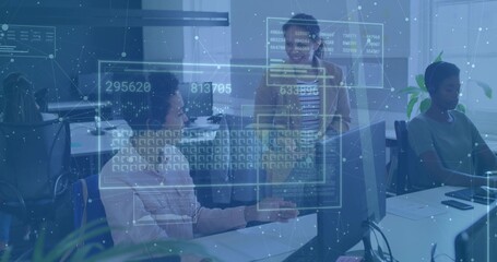 Working women in blouse, blazer typing at office desk with monitors, phone, papers and HUD overlays