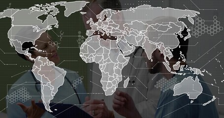 Reviewing three medics wearing scrubs and lab coats at ward, analyzing blue clipboard and world map