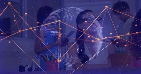 Collaborating woman with glasses seated center guiding team at co-working desk, with digital globe