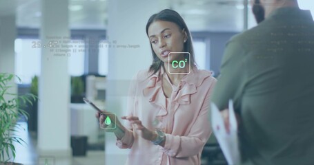 Showing woman in pink ruffled blouse tapping phone screen at office with AR CO2 droplet icons