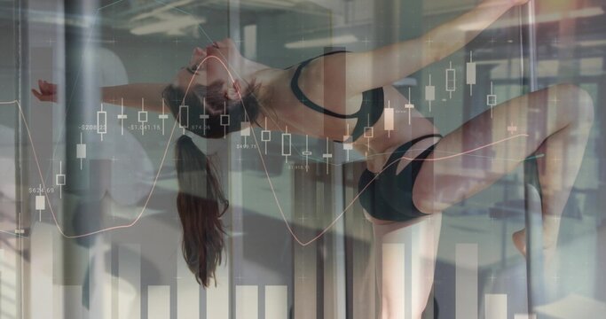 Doing inverted pole-dance in studio, pole-dancer wearing black sportswear, poles and charts overlay