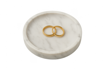 Gold wedding bands uniting on marble tray for marriage