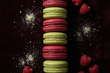 Vibrant Shell Raspberry and Pistachio Macarons Lined up on Purple Velvet