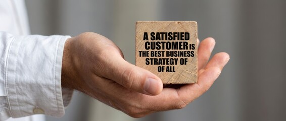 Customer Satisfaction Strategy Concept with Hand Holding Motivational Card in Business Environment Close-Up View