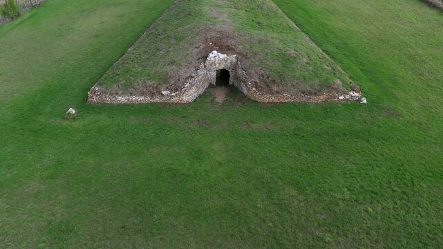 Stoney Littleton prehistoric Neolithic long barrow burial mound, Somerset. Aka Bath Tumulus, Wellow Tumulus. Dates from 3500 BC. View to west. Fly in down to passage entrance