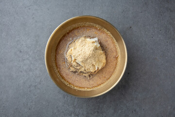 Korean Cold Soy Milk Noodles in Brass Bowl on Stone Background 놋그릇에 담긴 한국식 콩국수