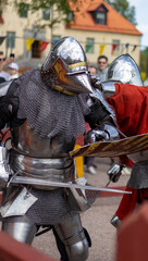 Naklejka premium Close view of medieval knights battling at fair