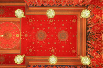 Wat Hualamphong, a royal Buddhist temple with ornate details and a colorful, chandelier lit hall in Bangkok, Thailand