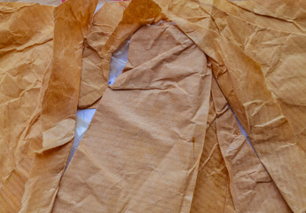 Old crumpled brown paper texture, ideal for various design projects, backgrounds, or crafts needing an organic and textured feel.