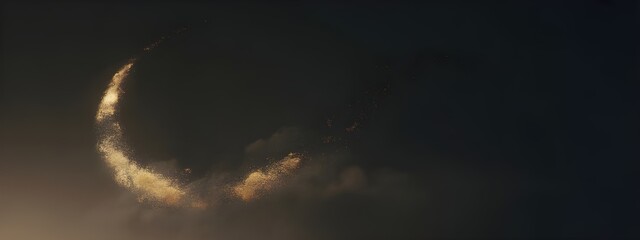 A crescent shaped formation of golden particles against a dark background
