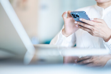 Hands of business woman using smartphone