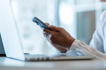 Hands of business woman using smartphone