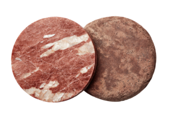 Two stone coasters, one marbled red/white, one rough textured brown
