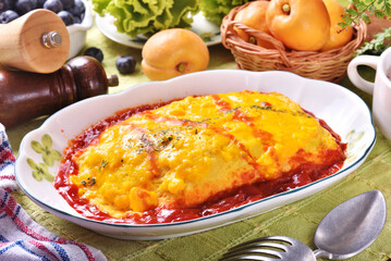 Japanese omelet rice on white plate.