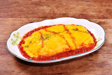 Japanese omelet rice on white plate.