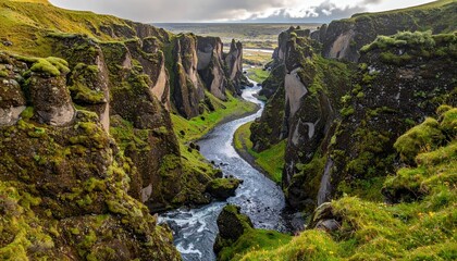 Obraz premium Stunning River Canyon Landscape with Greenery and Dramatic Sky