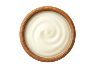 Creamy white sauce fills a round, wooden bowl, swirling softly from the center