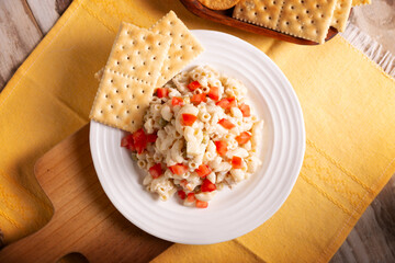 Macaroni Tuna salad with elbow pasta and canned tuna, served with saltine crackers. Easy and healthy recipe.