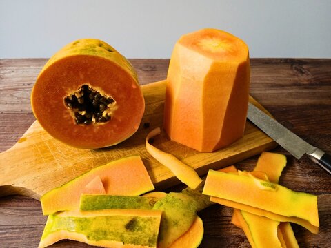 cut and peeled papaya on table
