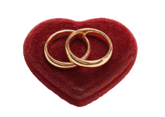 Two golden rings resting on a soft, red, heart-shaped, velvet box