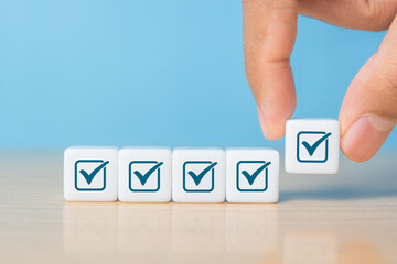 Hand holding dice with tick mark, good feedback rating and positive customer review, experience, satisfaction survey ,mental health assessment, checklist business concept © Achmad Khoeron