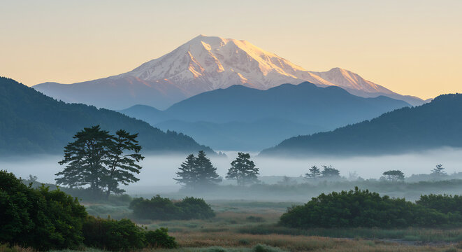 Golden sunrise light illuminates a towering snow-capped mountain rising over a tranquil misty valley. AI Generated - Powered by Adobe
