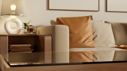 Empty glass top wooden table aside sofa couch and side table with lamp and coffee cup in living room