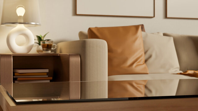 Empty glass top wooden table aside sofa couch and side table with lamp and coffee cup in living room