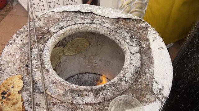 Indian-style roti prepared in a tandoor at a wedding in India