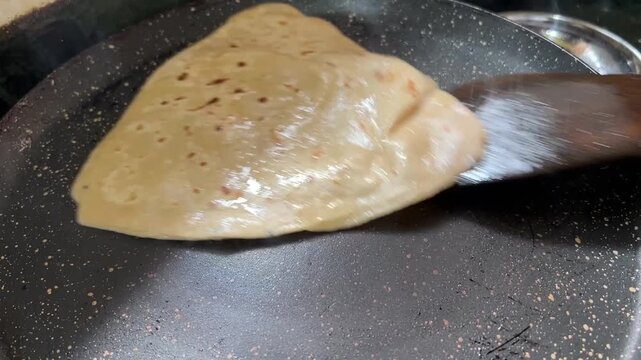 Triangle wheat Paratha prepared at a home in India