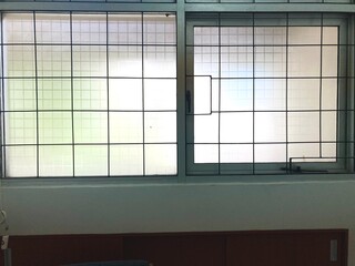 frosted glass window with black metal safety grill