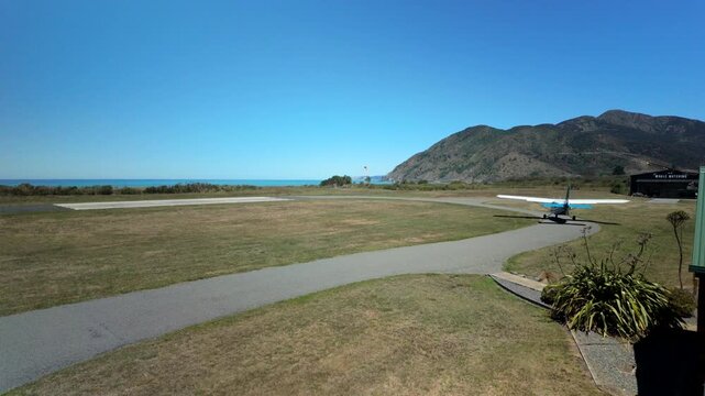 Small airplane turning onto runway at coastal aerodrome