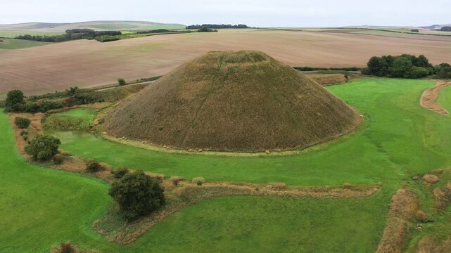 Silbury Hill prehistoric man made chalk and clay mound near Avebury stone circle henge, England. 39m high. Earliest dates from 2400BC. View from NE. Video fly in