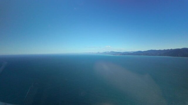 Ocean horizon view from helicopter cabin