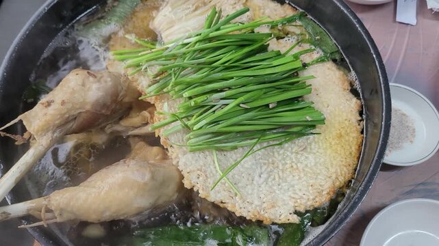 Korean Traditional Health Food Nurungji Baeksuk, Boiled Chicken with Scorched Rice Sizzling in a Pot