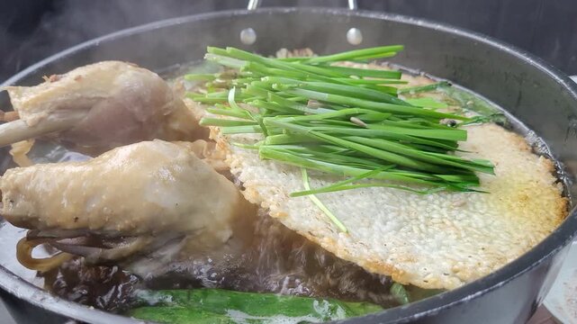 Korean Traditional Health Food Nurungji Baeksuk, Boiled Chicken with Scorched Rice Sizzling in a Pot