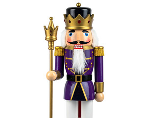 A regal wooden king nutcracker with purple uniform and crown, holding a staff