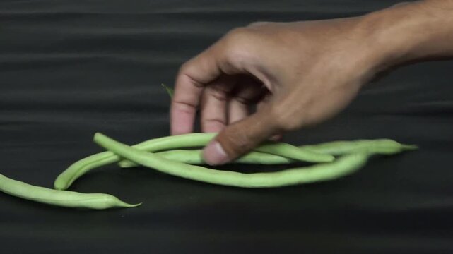 Fresh Green Beans Scattered on Dark Background