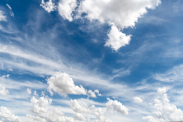 Cumulus and cirrus clouds in the blue sky