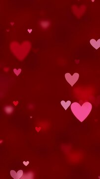 Red and pink hearts twinkling on red background for Valentine's day. Heart particles sparkling for romantic theme celebrating love, passion, or for a Valentines day background.