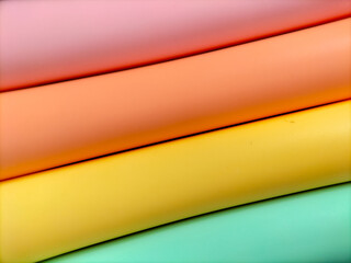 Soft pastel colors are arranged in parallel, curved bands. 