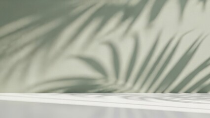 Soft green wall with palm leaf shadows and white surface