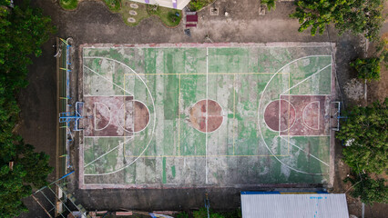Aerial View of Weathered Outdoor Basketball Court with Green and Red Markings