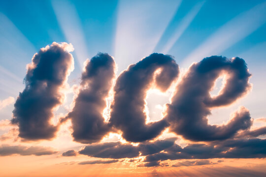 Hopeful clouds form uplifting message at sunset with sun rays