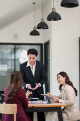Fototapeta premium Asian businessman stands explaining a business investment opportunity. 