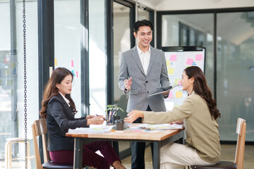 Fototapeta premium A businessman is standing at the office giving a presentation.