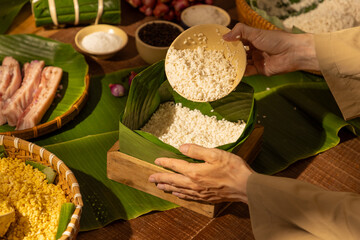 Traditional Vietnamese Chung cake ingredients arranged during Tet preparation, showing cultural...